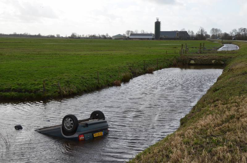 Auto slaat over de kop en raakt te water