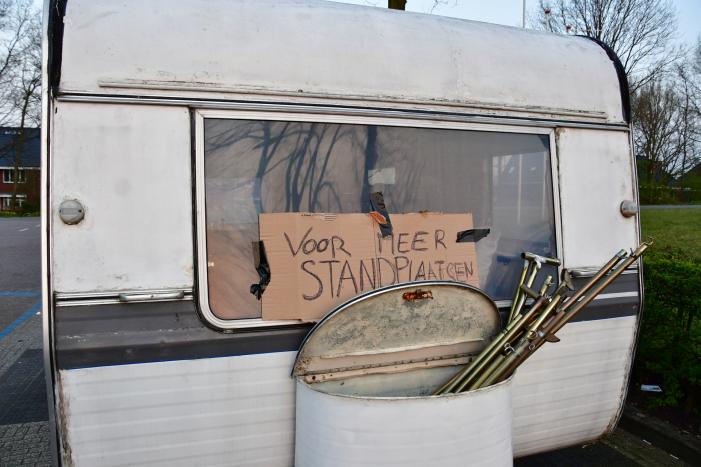 Handhaving sleept caravan met protesttekst weg van parkeerterrein gemeentewerf
