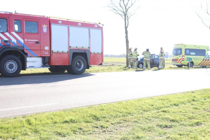 Auto botst op boom, inzittende bekneld