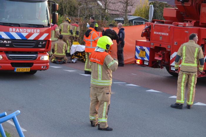 Man bekneld onder as van bedrijfswagen