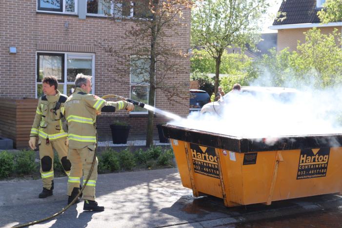 Bewoners blussen brand in bouwcontainer met puin