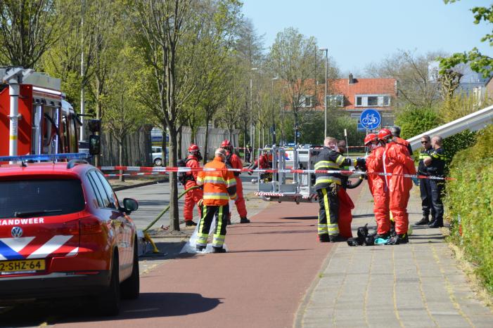 Brandweer in beschermende pakken halen persoon uit woning