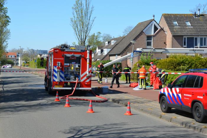 Brandweer in beschermende pakken halen persoon uit woning