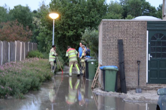 Groot sinkhole en straat vol water na leidingbreuk