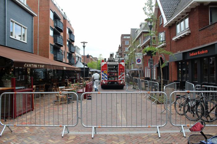 Woningbrand in winkelstraat