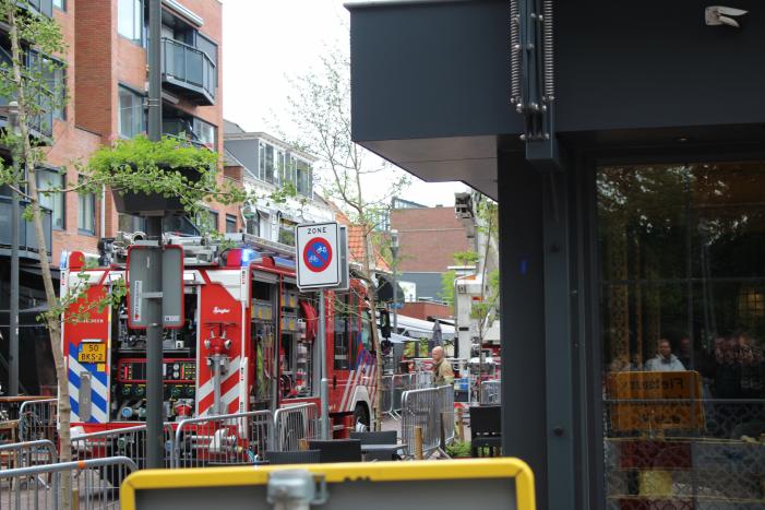 Woningbrand in winkelstraat