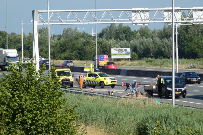 Aanhanger met zand slaat over de kop