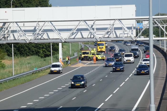 Aanhanger met zand slaat over de kop
