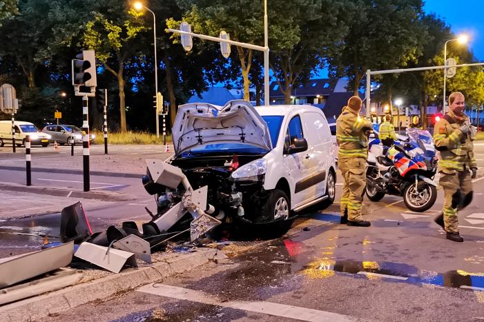 Bestelbus rijdt verkeerslicht uit de grond