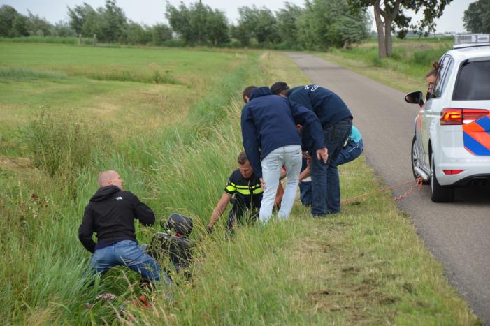 Omstanders halen scootmobiel uit greppel