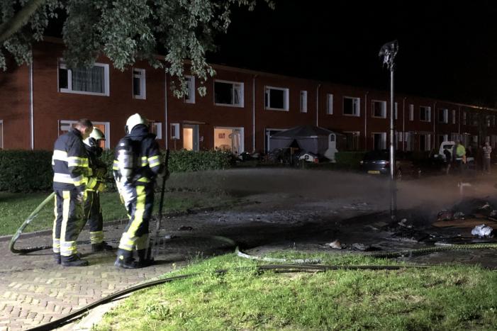 Stapel grofvuil laat lantaarnpaal branden