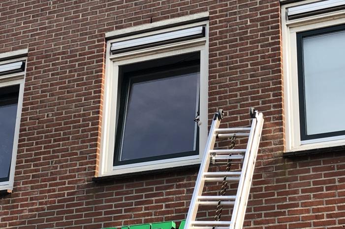 Kat vast tussen klapraam