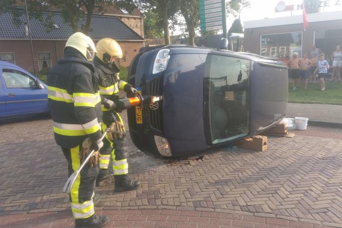 Auto op zijn kant na verkeersongeval