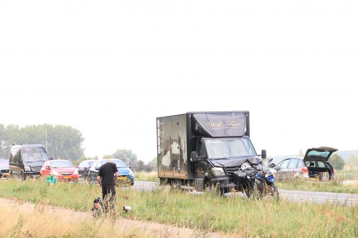 Bestelbus botst achter op motor