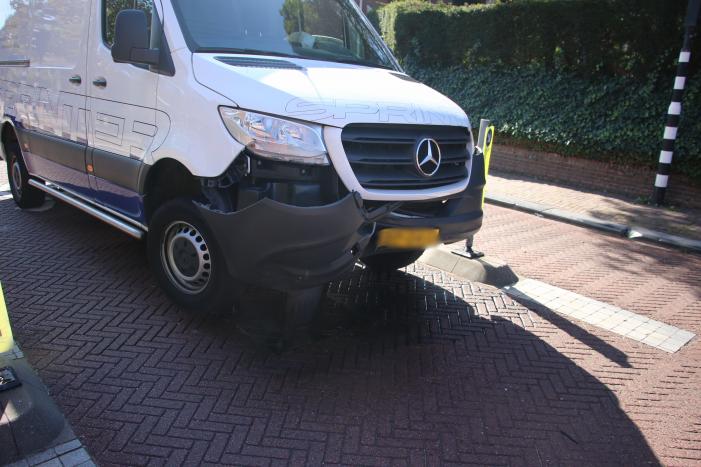 Bestelbus komt vast te zitten op paal van bussluis