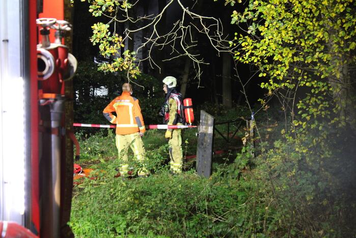 Brand in schuur in bos