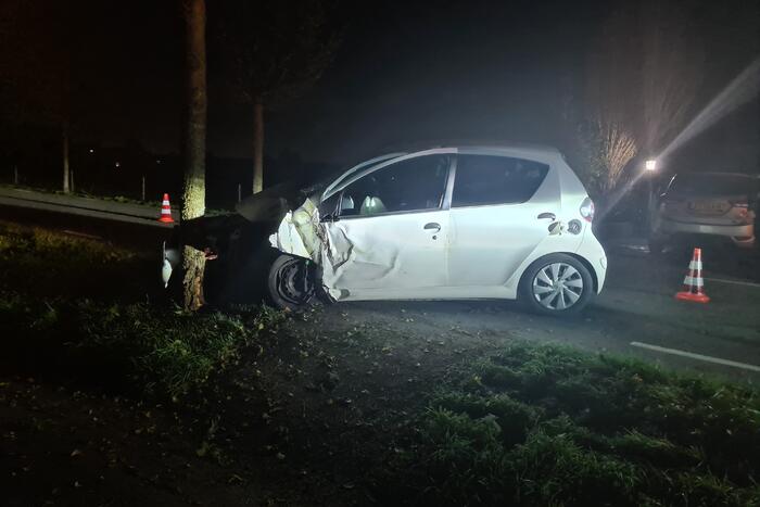 Auto rijdt tegen lantaarnpaal en komt tot stilstand tegen boom