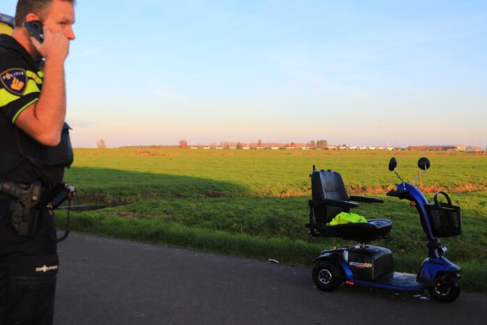 Man met scootmobiel te water