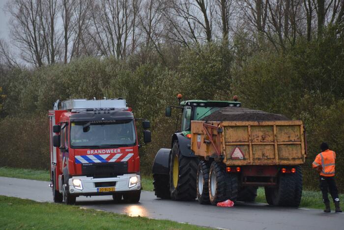 Tractor met lading zand vat vlam