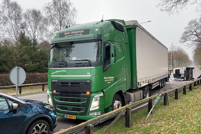 Bestelbus belandt op zijn kant via vangrail