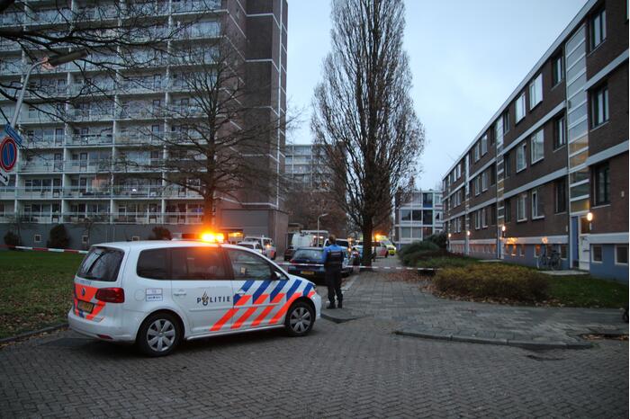 Verward persoon op galerij van flatwoning