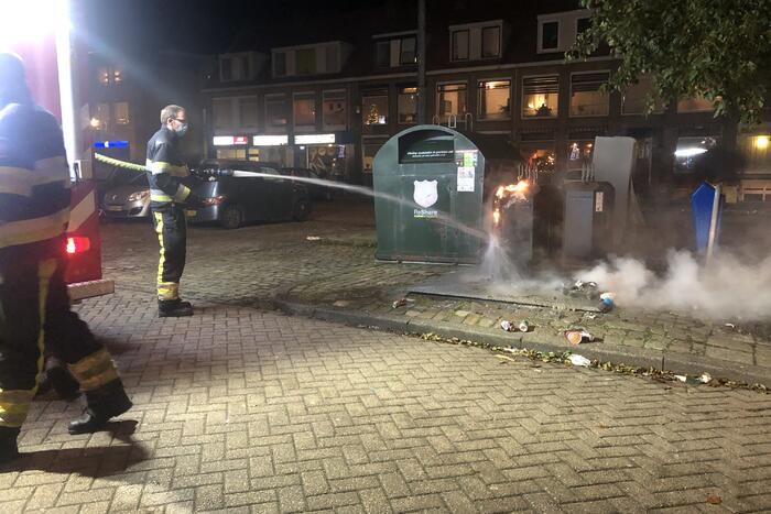 Papier in brand naast container