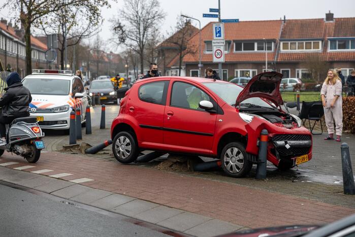 Auto vliegt uit de bocht en belandt op paaltjes