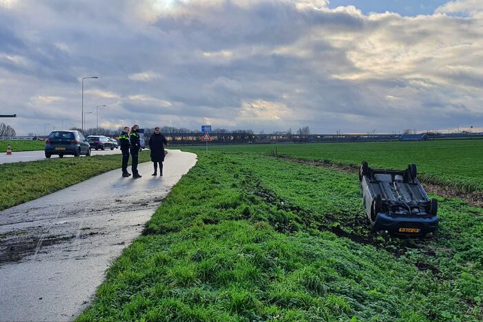 Personenauto raakt van de weg en belandt op zijn dak