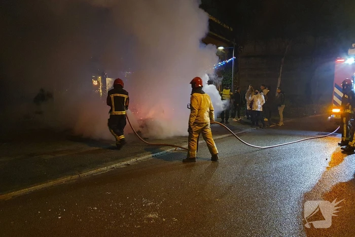 Brandweer blust brandend afval
