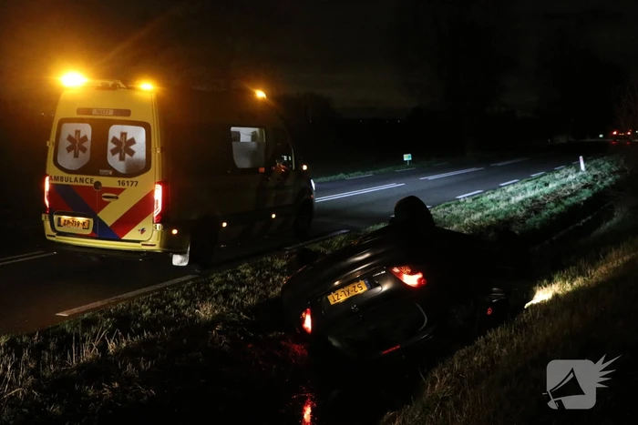 Auto belandt op dak in sloot