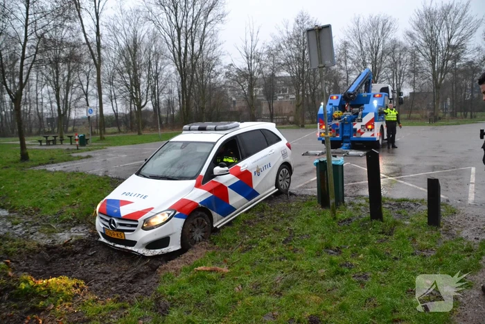 Politieauto rijdt zich vast in modder