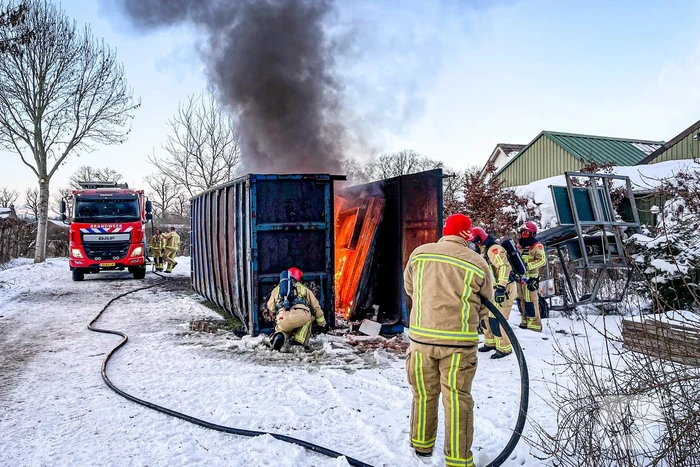Felle brand in container met bouwafval