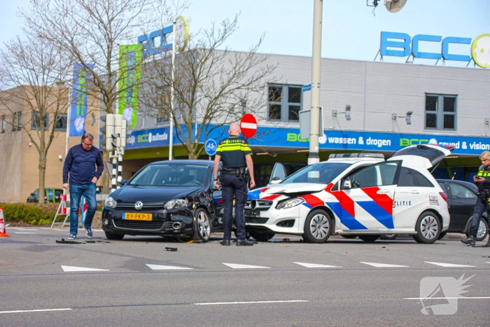 Politieauto met spoed ramt personenauto