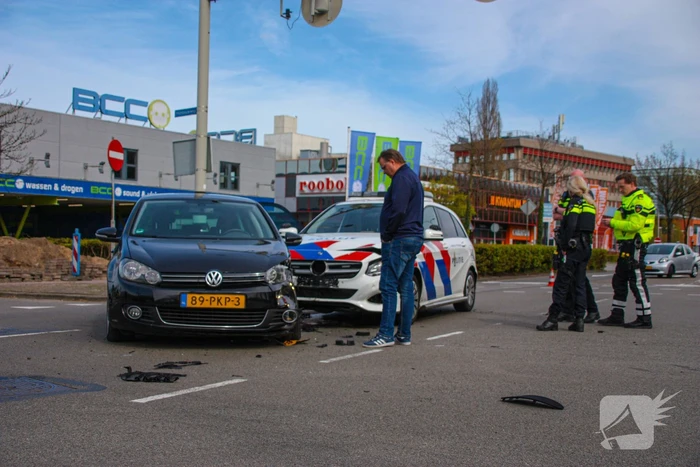 Politieauto met spoed ramt personenauto