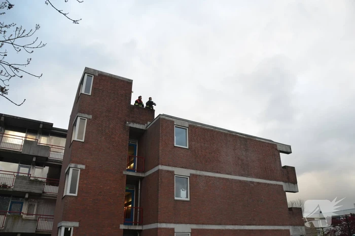 Brandweer boort schroeven in bijna loskomende dakrand