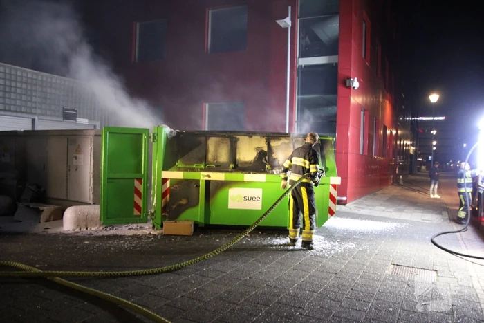 Bouwcontainer vol papier vat vlam