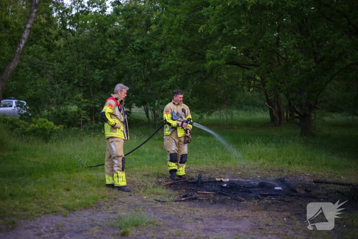 Stapel houten takken in brand in bosgebied De Bergjes