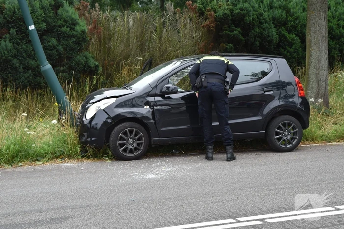Automobilist parkeert auto tegen lantaarnpaal