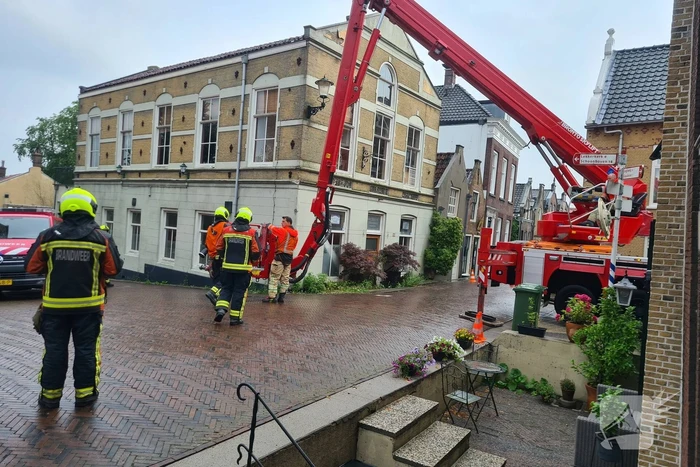 Stukken steen vallen van woning