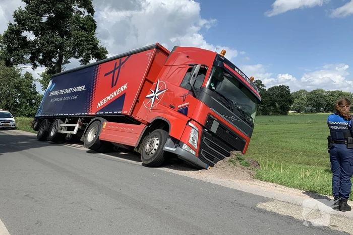 Vrachtwagen met oplegger komt vast te zitten in greppel