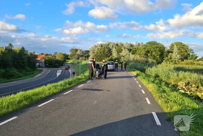 Persoon ten val met scooter
