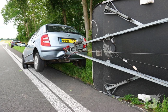 Auto met caravan belandt op zijn kant