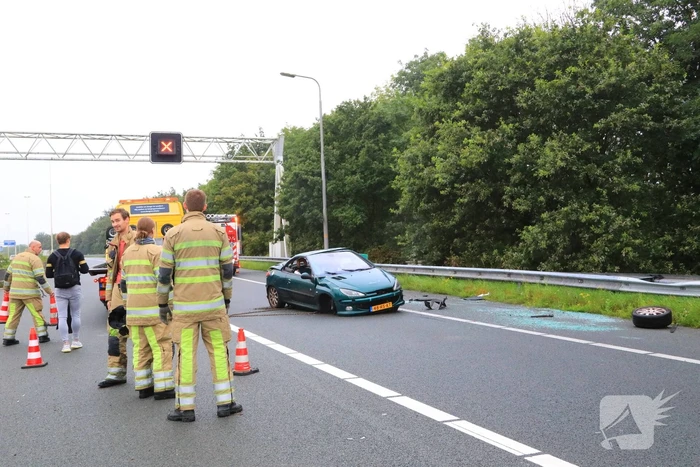 Auto glijdt over vangrail heen en belandt op zijn kop