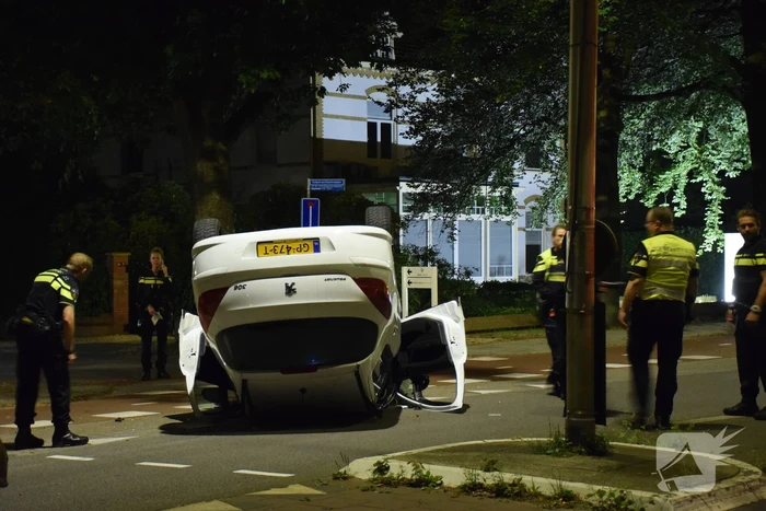 Auto op zijn kop tot stilstand na botsing tegen paal