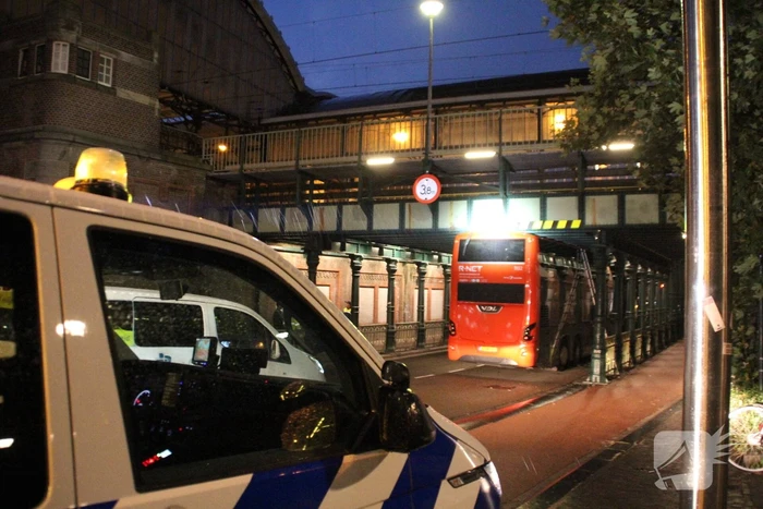 Stadsbus van R-NET rijdt zich klem onder spoorviaduct