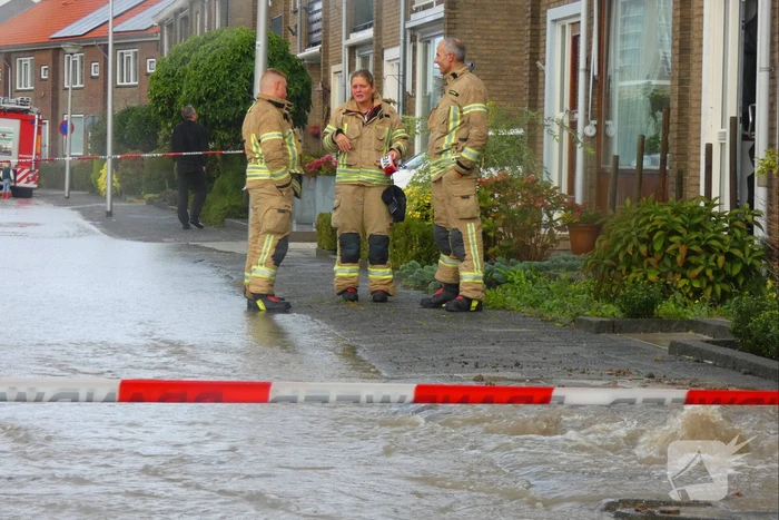 Straat onderwater door gesprongen waterleiding