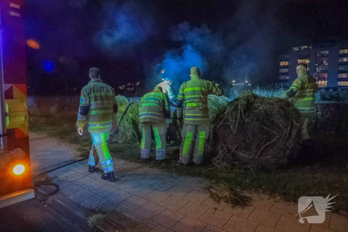 Broeiende hooibalen uit elkaar gehaald