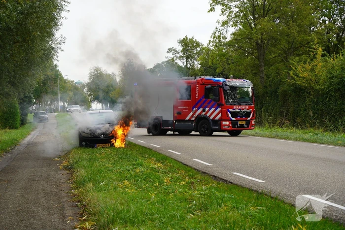 Brandweer blust brand in personenauto