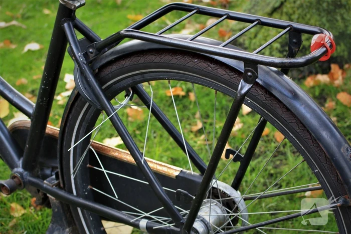 Meisje vast met voet tussen spaken van fiets