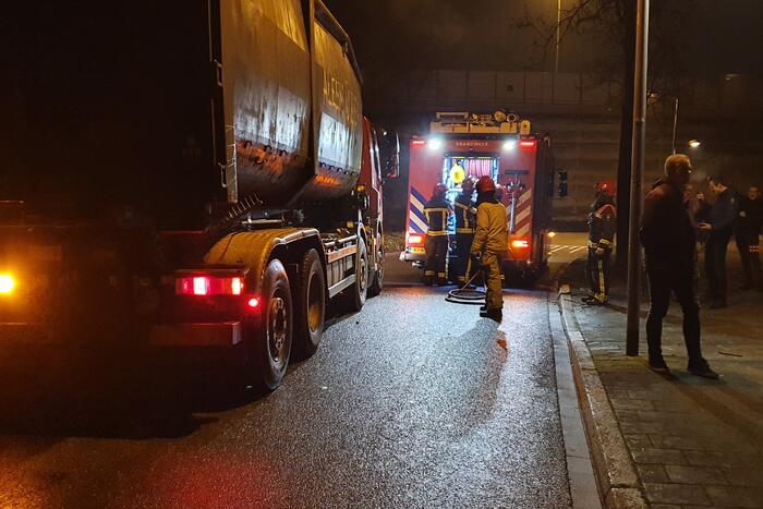 Brandweer blust brandend afval